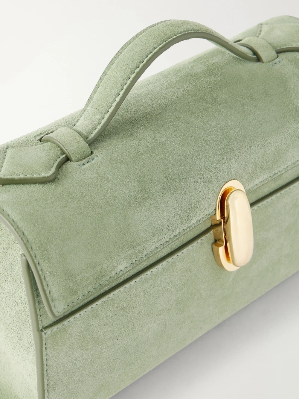 Close-up detail of the Savette Symmetry Pochette Suede Top-handle Bag