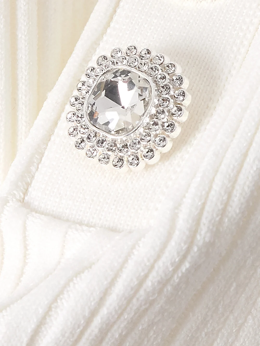 Close-up detail of the Self-Portrait Off-the-shoulder Pleated Ribbed-knit Mini Dress
