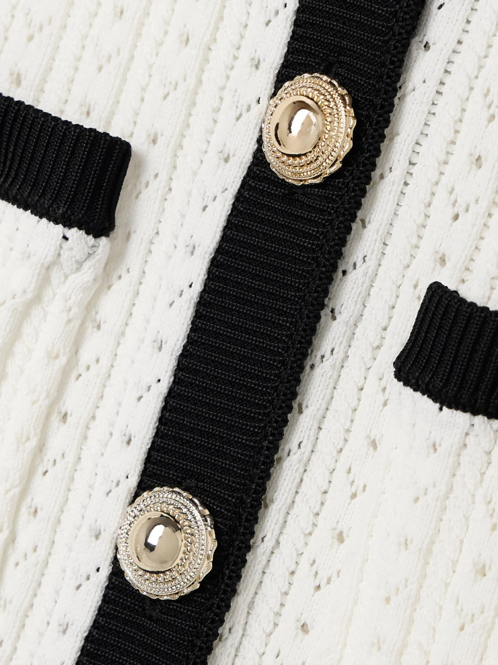 Close-up detail of the Self-Portrait Pointelle-knit Peplum Midi Dress