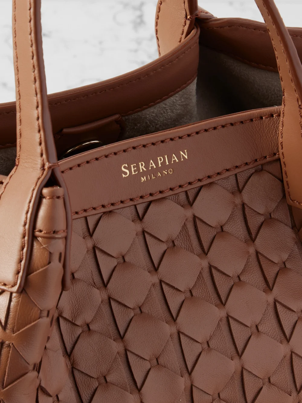 Close-up detail of the Serapian Secret Mini Woven Leather Shoulder Bag