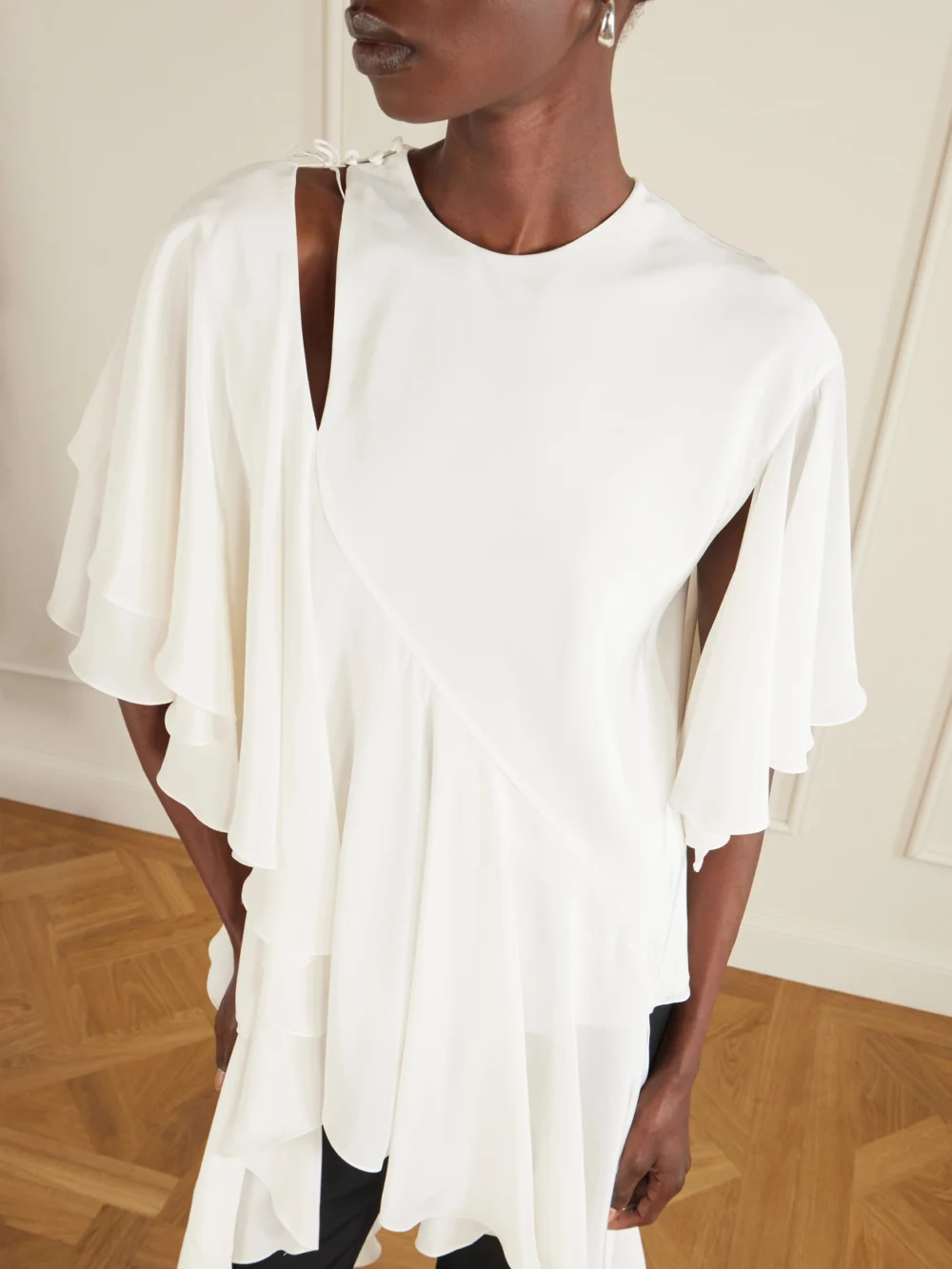 Close-up detail of the Sharon Wauchob Thea Asymmetric Ruffled Cutout Silk Top