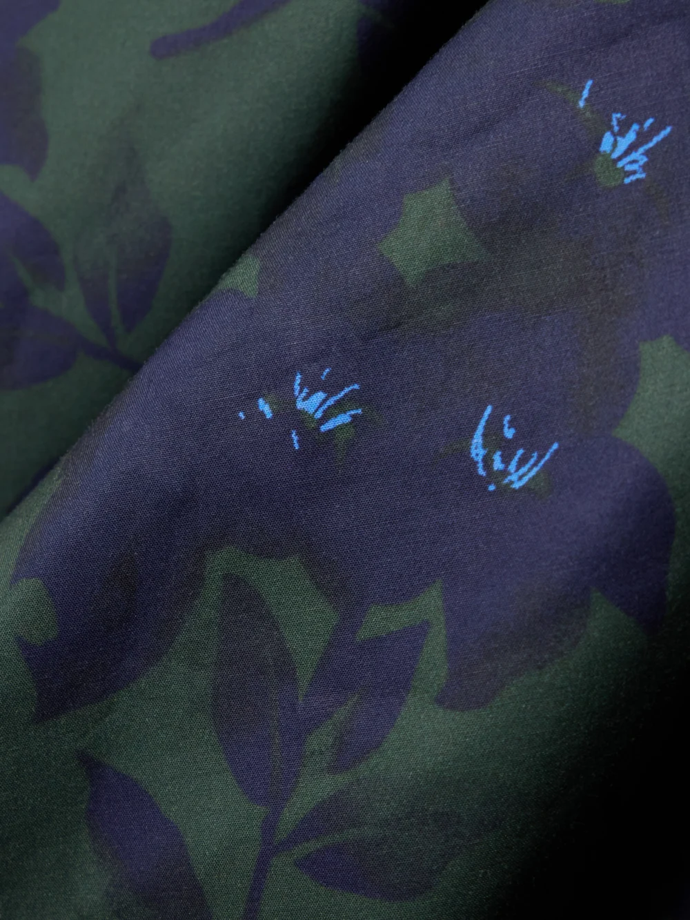 Close-up detail of the Shushu/Tong Asymmetric Bow-embellished Floral-print Cotton Midi Skirt