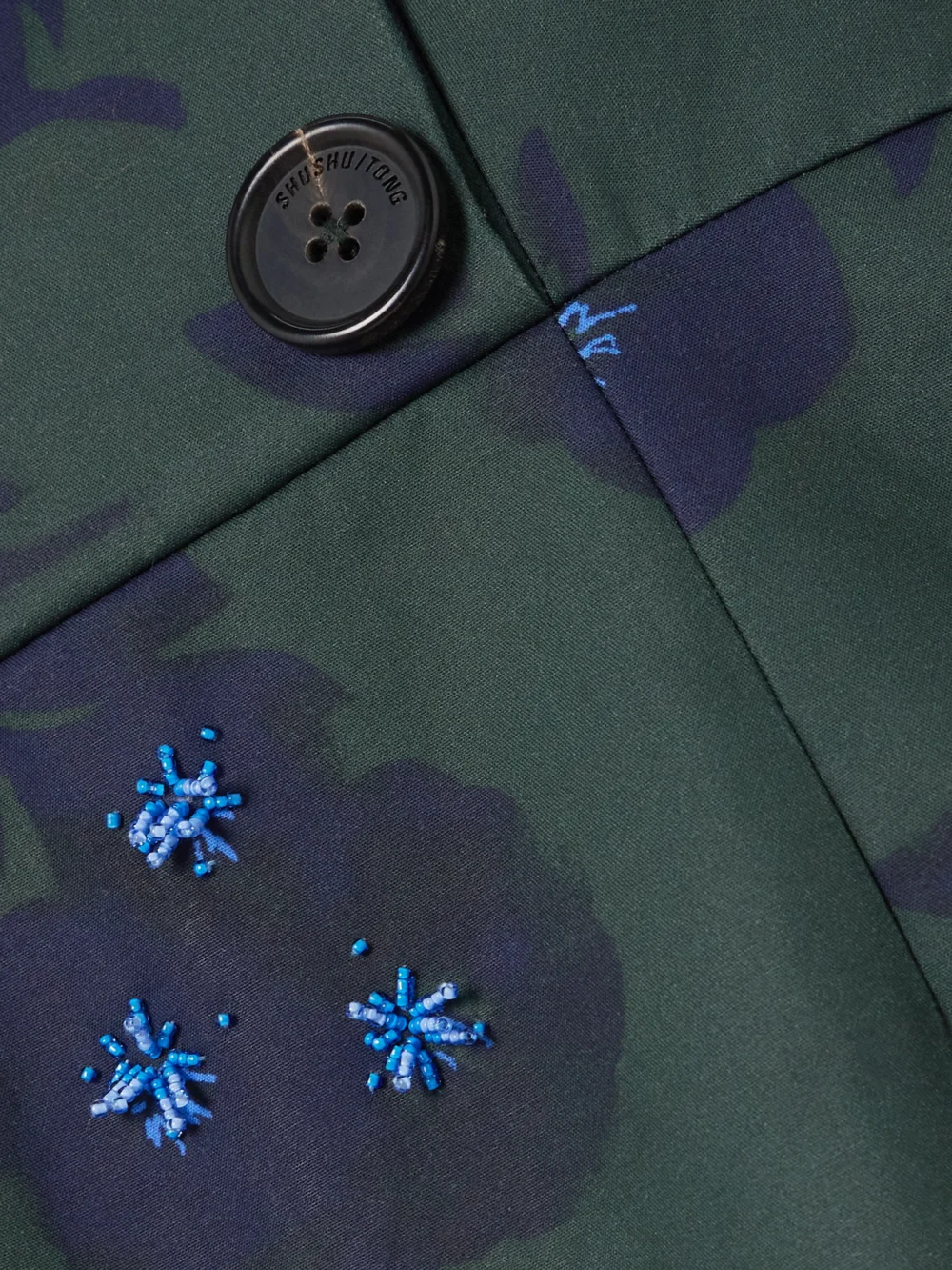 Close-up detail of the Shushu/Tong Asymmetric Off-the-shoulder Embellished Floral-print Cotton Mini Dress