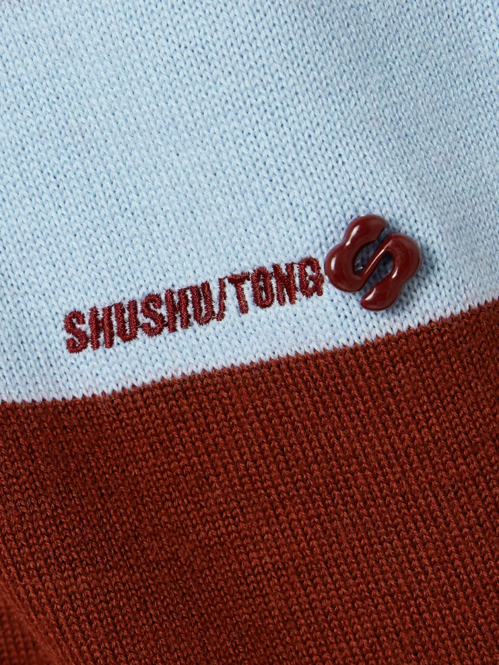 Close-up detail of the Shushu/Tong Striped Knitted Polo Sweater