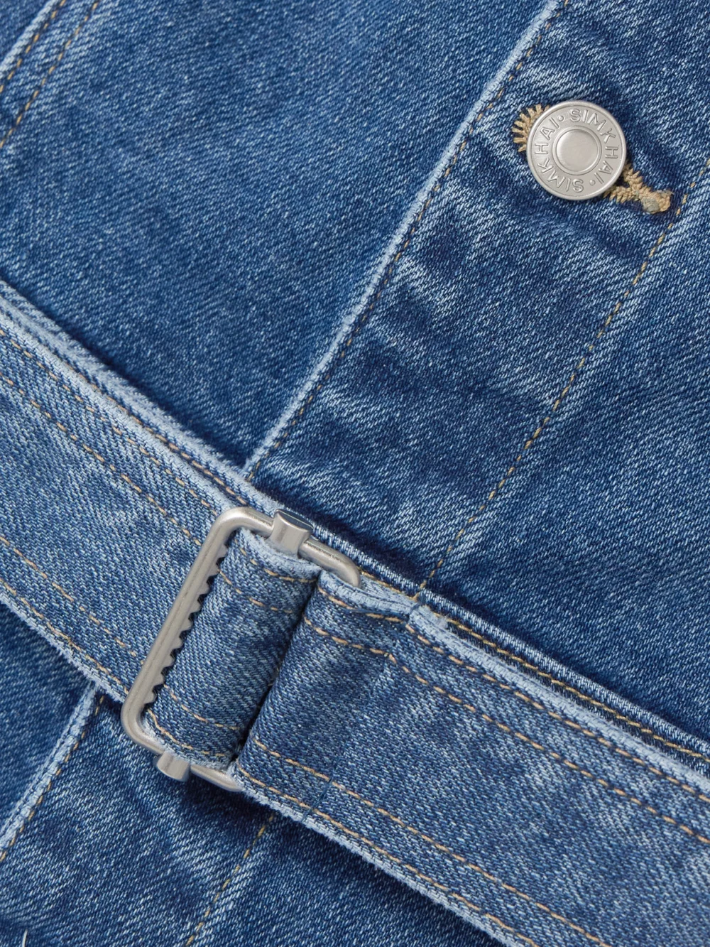 Close-up detail of the Simkhai Alba Belted Stretch-denim Midi Dress