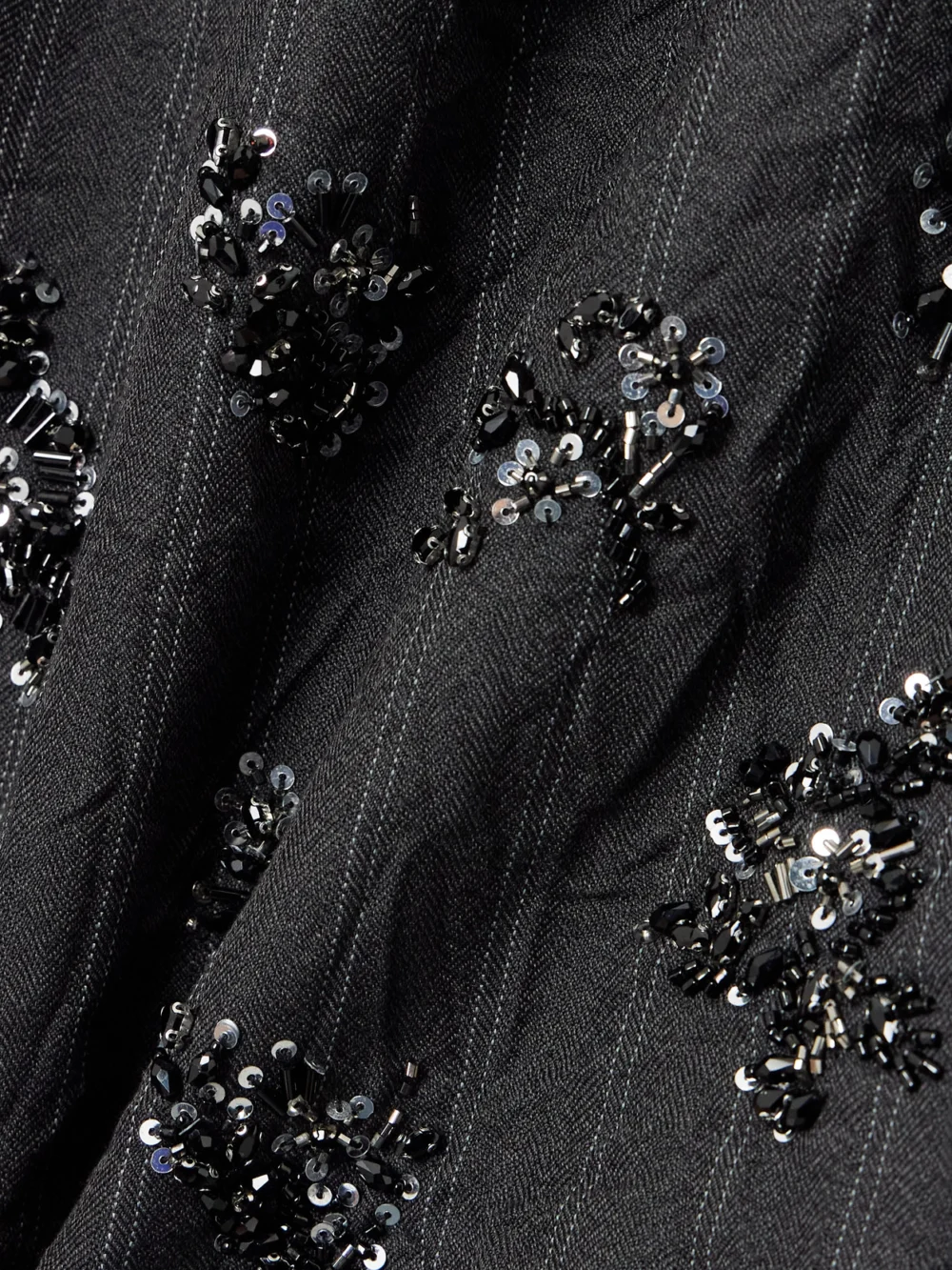Close-up detail of the Simkhai Anden Embellished Striped Woven Mini Dress