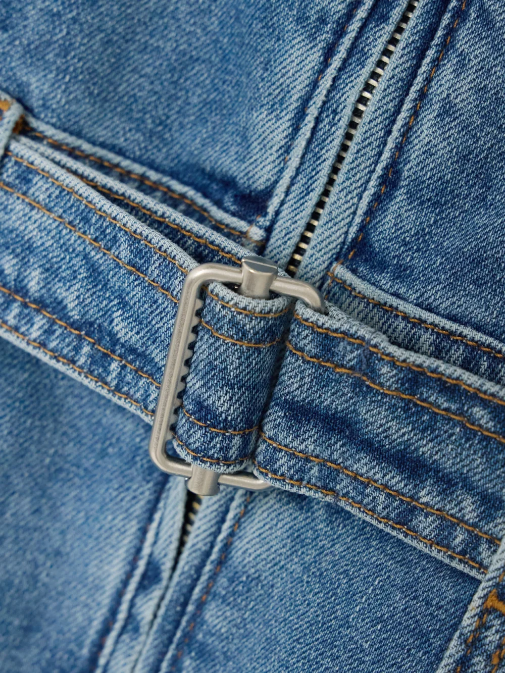 Close-up detail of the Simkhai Manson Belted Denim Midi Dress