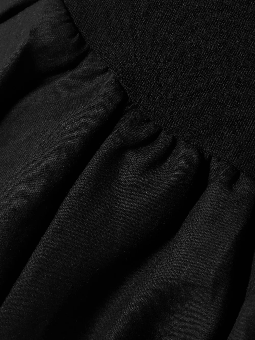 Close-up detail of the Simkhai Pollie Strapless Stretch Recycled-knit and Linen-blend Mini Dress