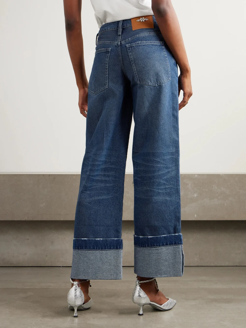Back view of the Simone Rocha Embellished Distressed Wide-leg Jeans