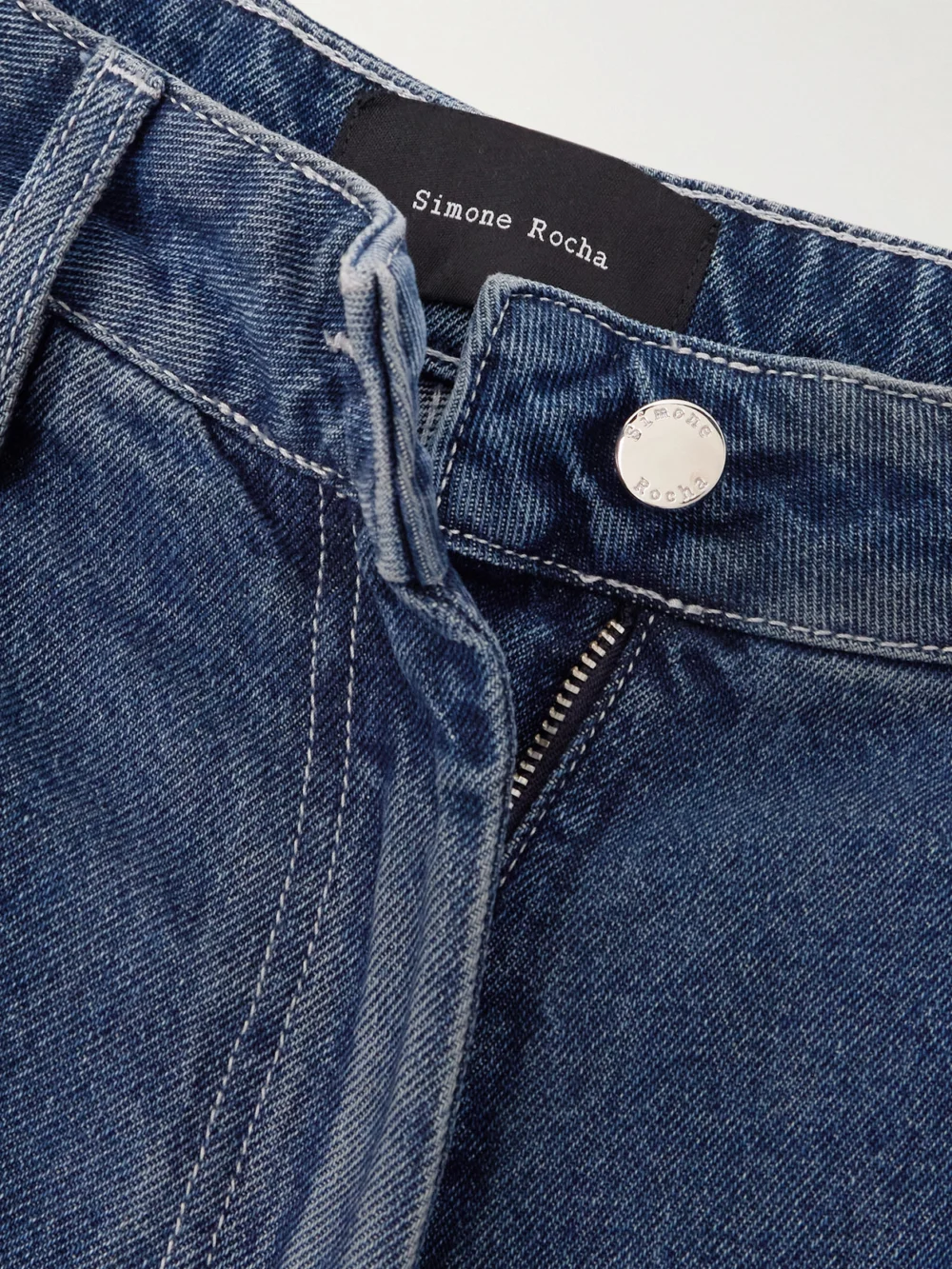 Close-up detail of the Simone Rocha Embellished Distressed Wide-leg Jeans