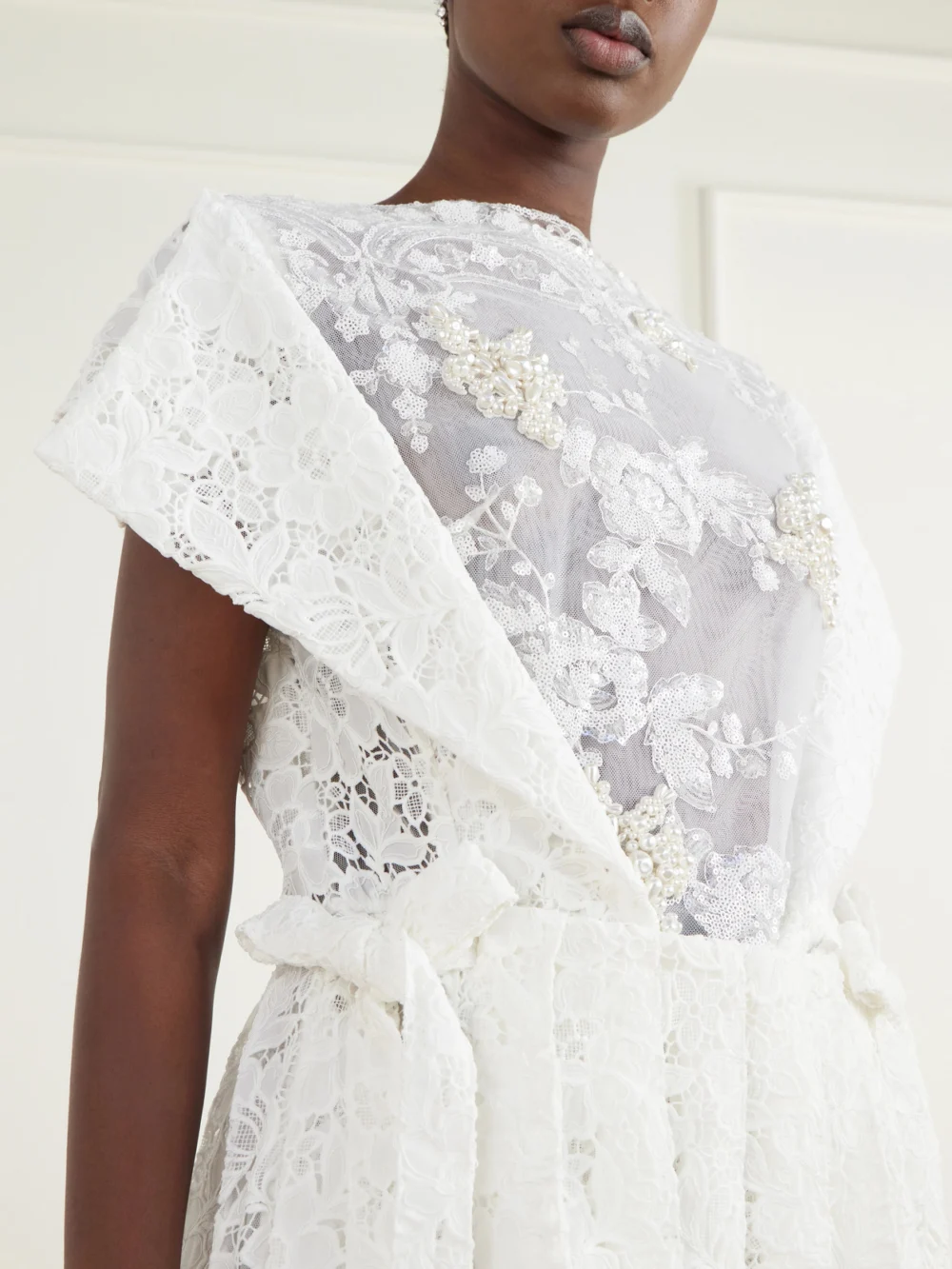 Close-up detail of the Simone Rocha Embellished Pleated Lace Midi Dress
