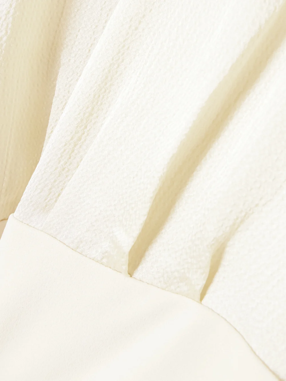 Close-up detail of the Solace London Rosalia Cape-effect Belted Satin and Crepe Gown