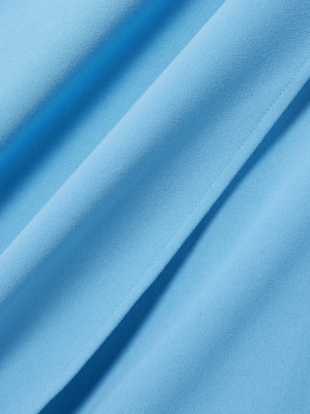 Close-up detail of the Solace London Sadie Cape-effect Crepe Gown