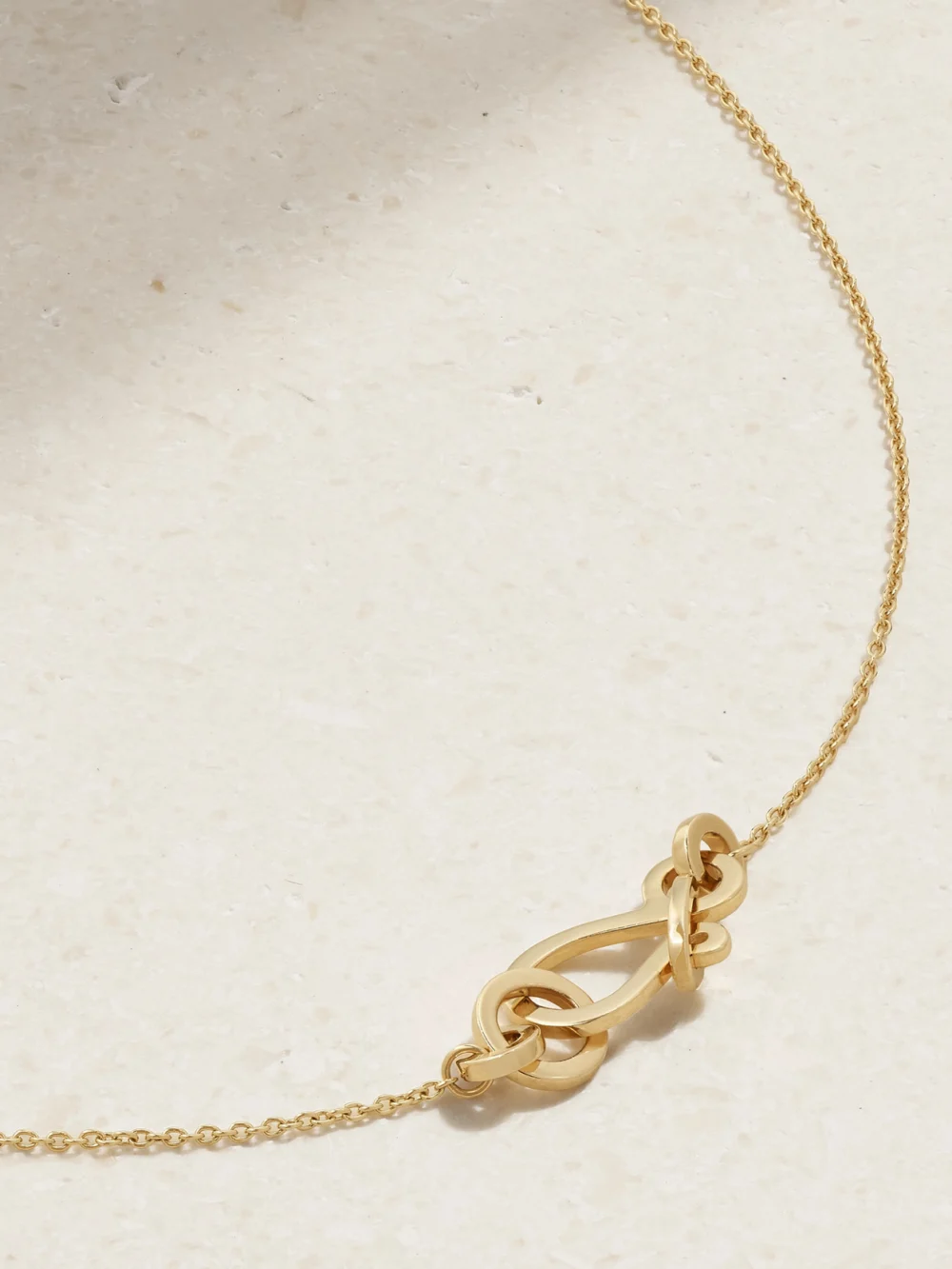 Back view of the Sophie Bille Brahe Bow Simple 14-karat Recycled Gold Necklace