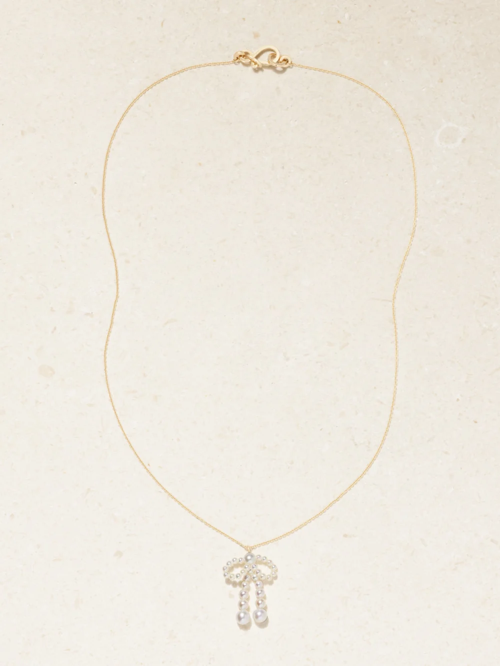 Close-up detail of the Sophie Bille Brahe Bow Simple 14-karat Recycled Gold Necklace