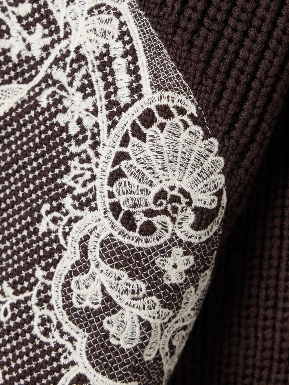 Close-up detail of the S.S. Daley Embroidered Ribbed Merino Wool Turtleneck Sweater