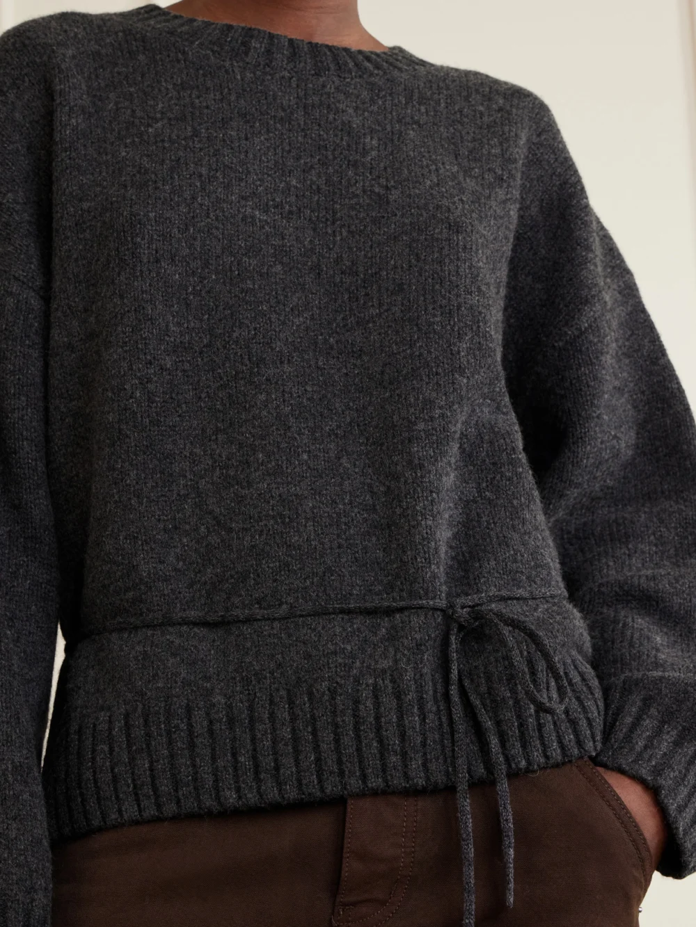 Close-up detail of the St. Agni Belted Wool Sweatshirt