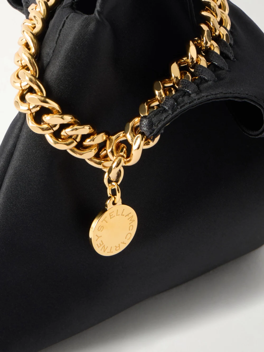 Close-up detail of the Stella McCartney Falabella Logo-embellished Gold-tone and Satin Wristlet Tote