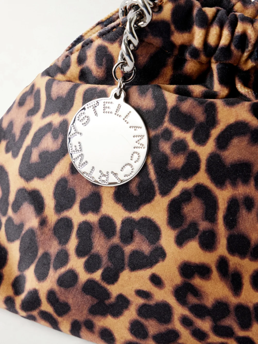 Close-up detail of the Stella McCartney Falabella Mini Leopard-print Velvet Drawstring Bag