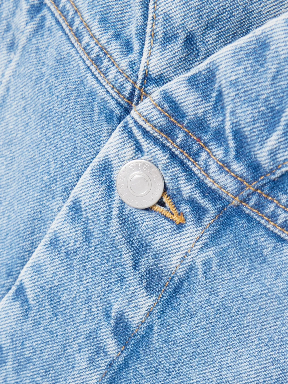 Close-up detail of the Stella McCartney Frayed Paneled Organic Denim Mini Dress