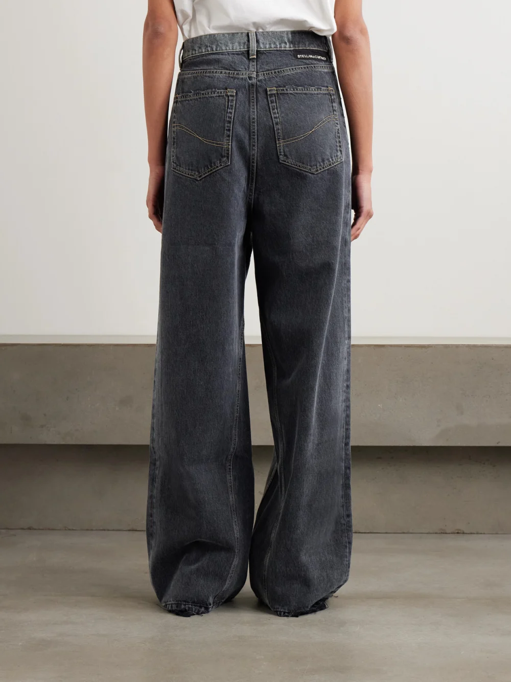 Back view of the Stella McCartney Frayed Two-tone Mid-rise Wide-leg Organic Jeans