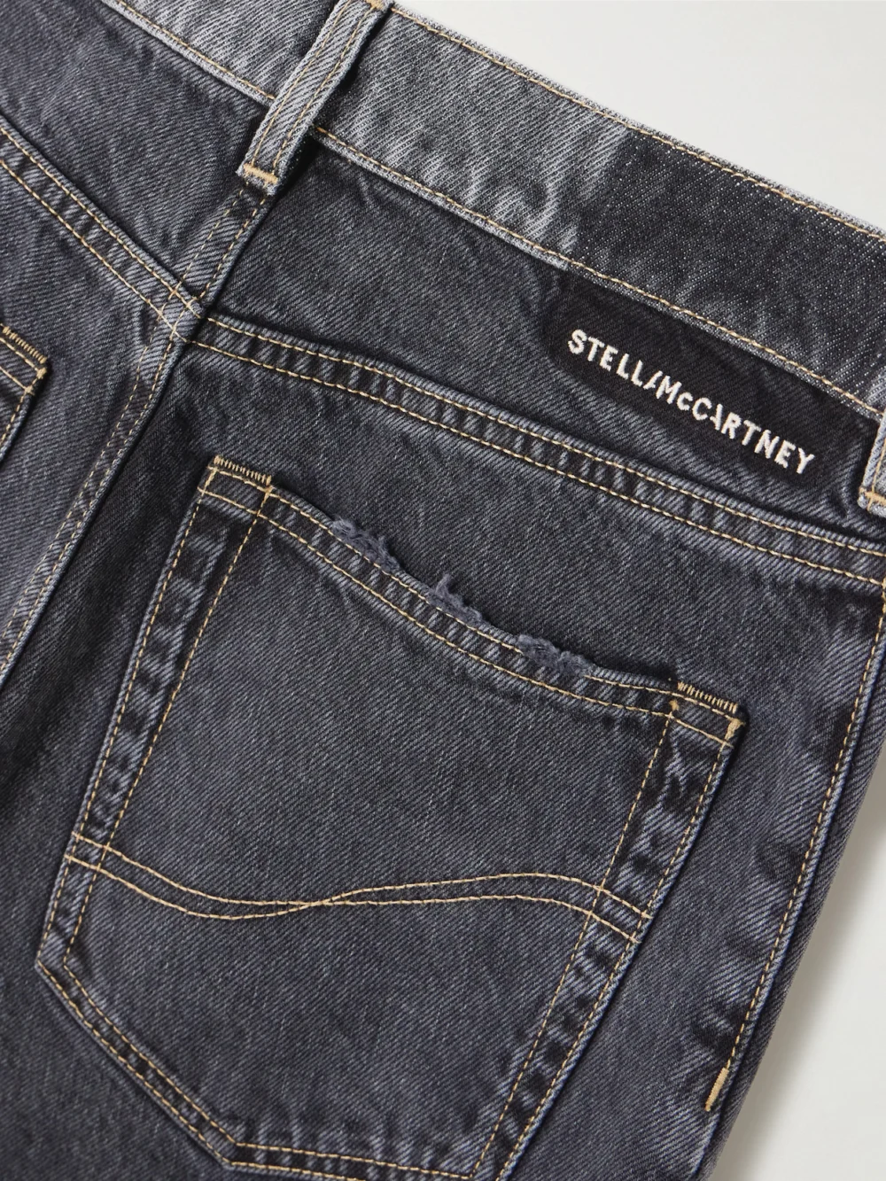 Close-up detail of the Stella McCartney Frayed Two-tone Mid-rise Wide-leg Organic Jeans