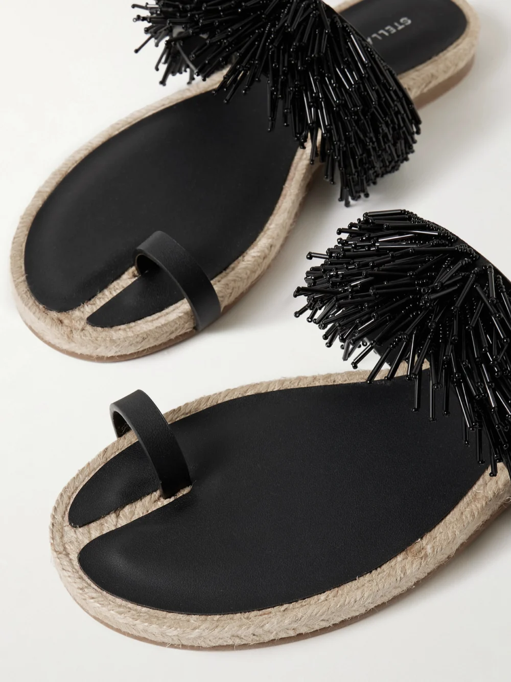 Close-up detail of the Stella McCartney Gaia Bead-embellished Faux-leather Trimmed Raffia Sandals
