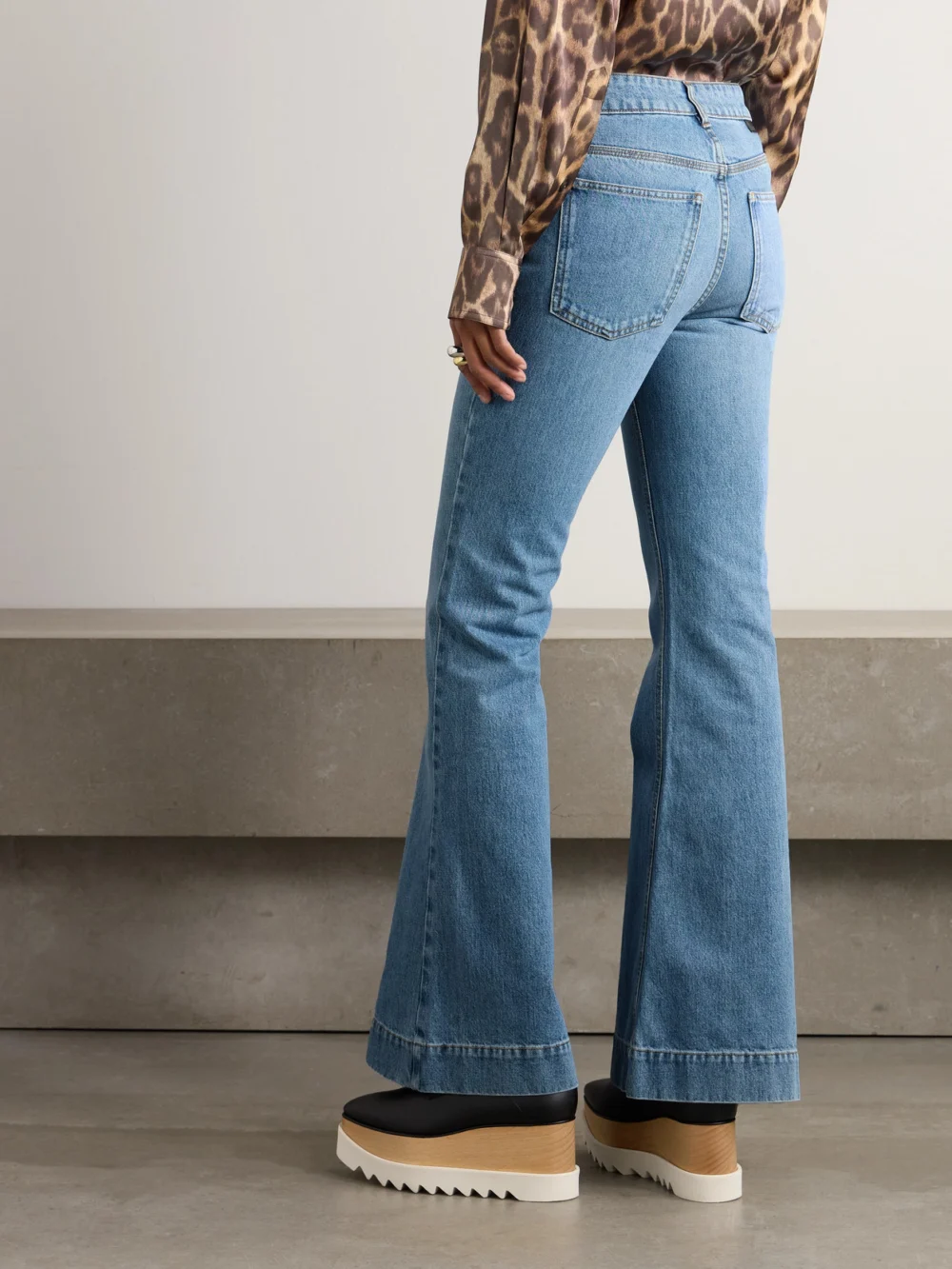 Back view of the Stella McCartney Iconic Chain-embellished High-rise Flared Jeans