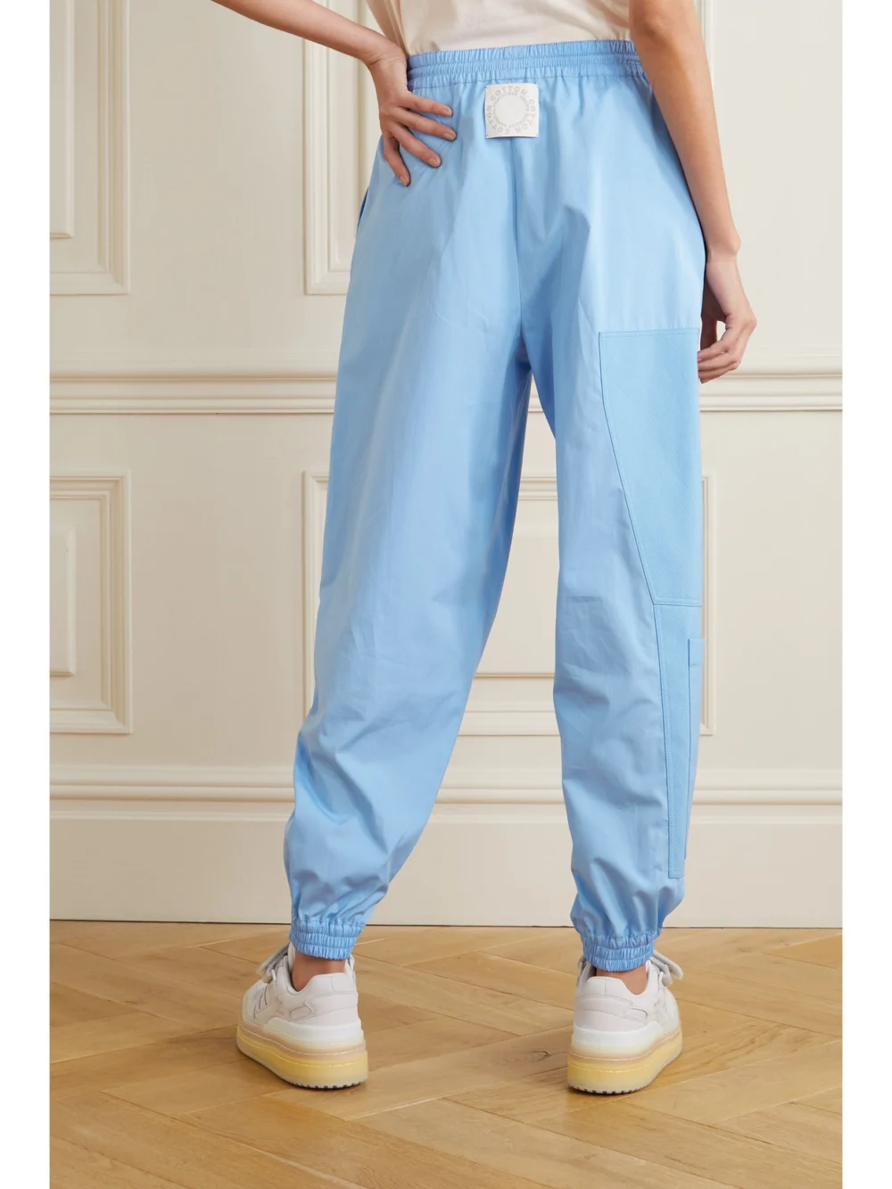 Back view of the Stella McCartney Kara Paneled Organic Cotton-ripstop and Shell Track Pants