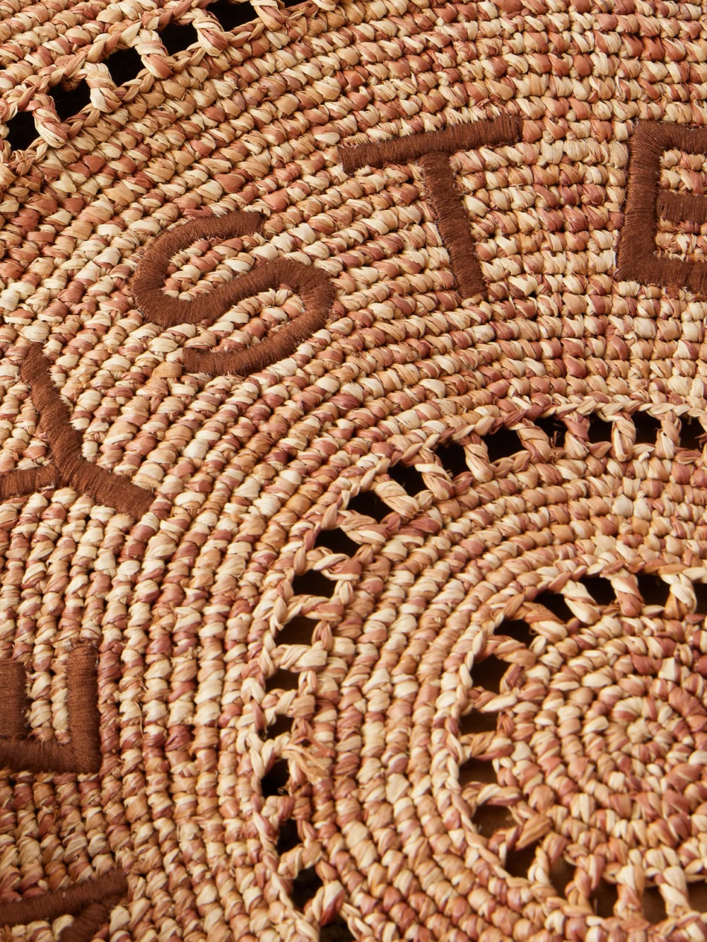 Close-up detail of the Stella McCartney Logo-embroidered Raffia Tote Bag
