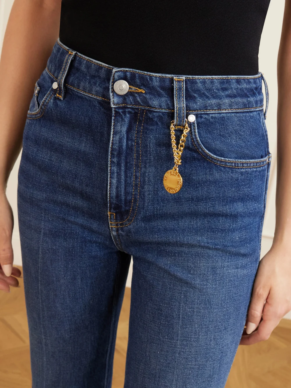 Close-up detail of the Stella McCartney Mid-rise Cropped Flared Jeans