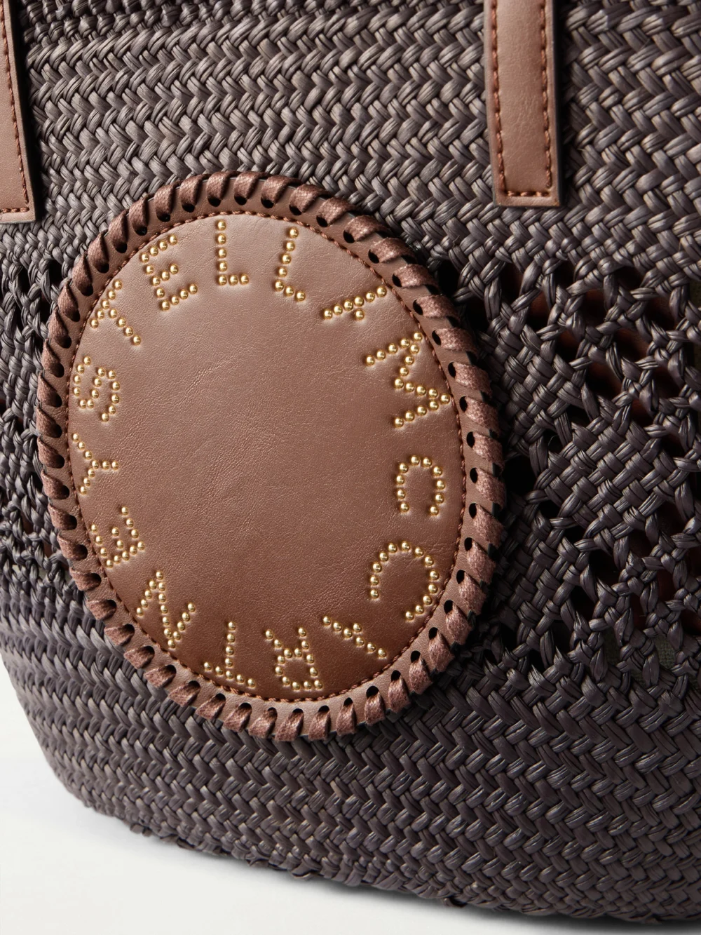 Close-up detail of the Stella McCartney Small Vegetarian Material-trimmed Raffia Tote