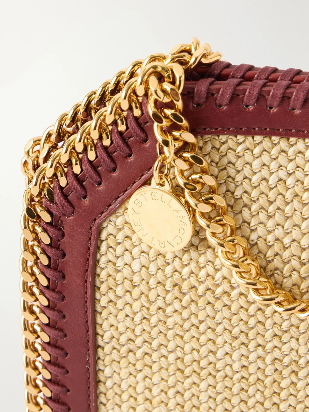 Close-up detail of the Stella McCartney The Falabella Tiny Vegetarian Material-trimmed Raffia Shoulder Bag