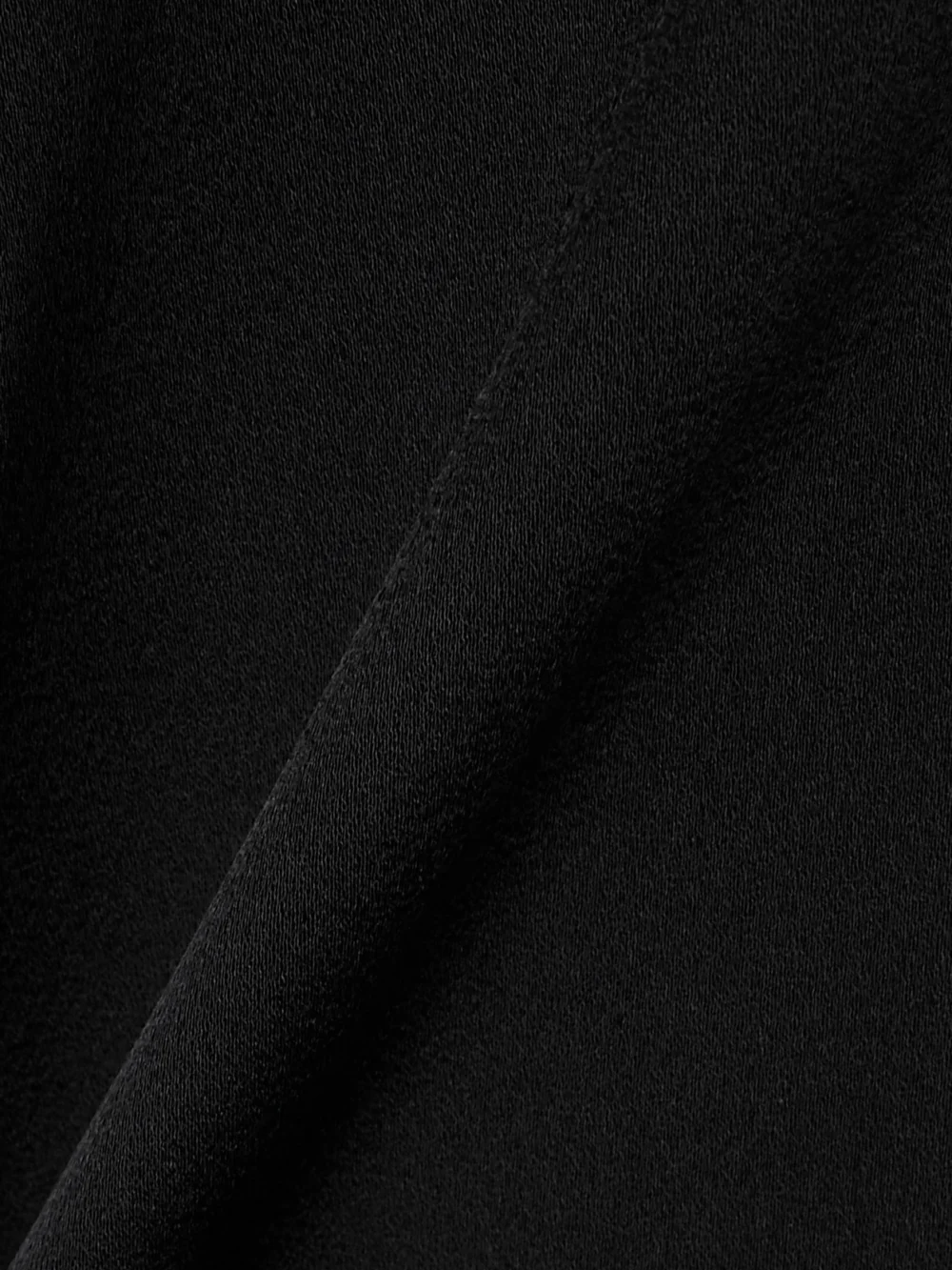 Close-up detail of the Stella McCartney Tie-neck Satin-crepe Mini Dress