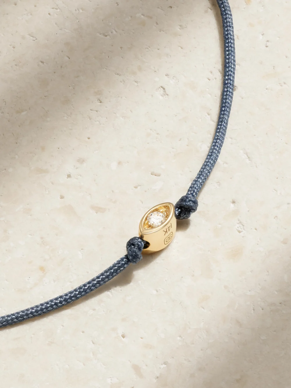 Close-up detail of the Sydney Evan Tiny Evil Eye 14-karat Gold, Cord and Diamond Bracelet