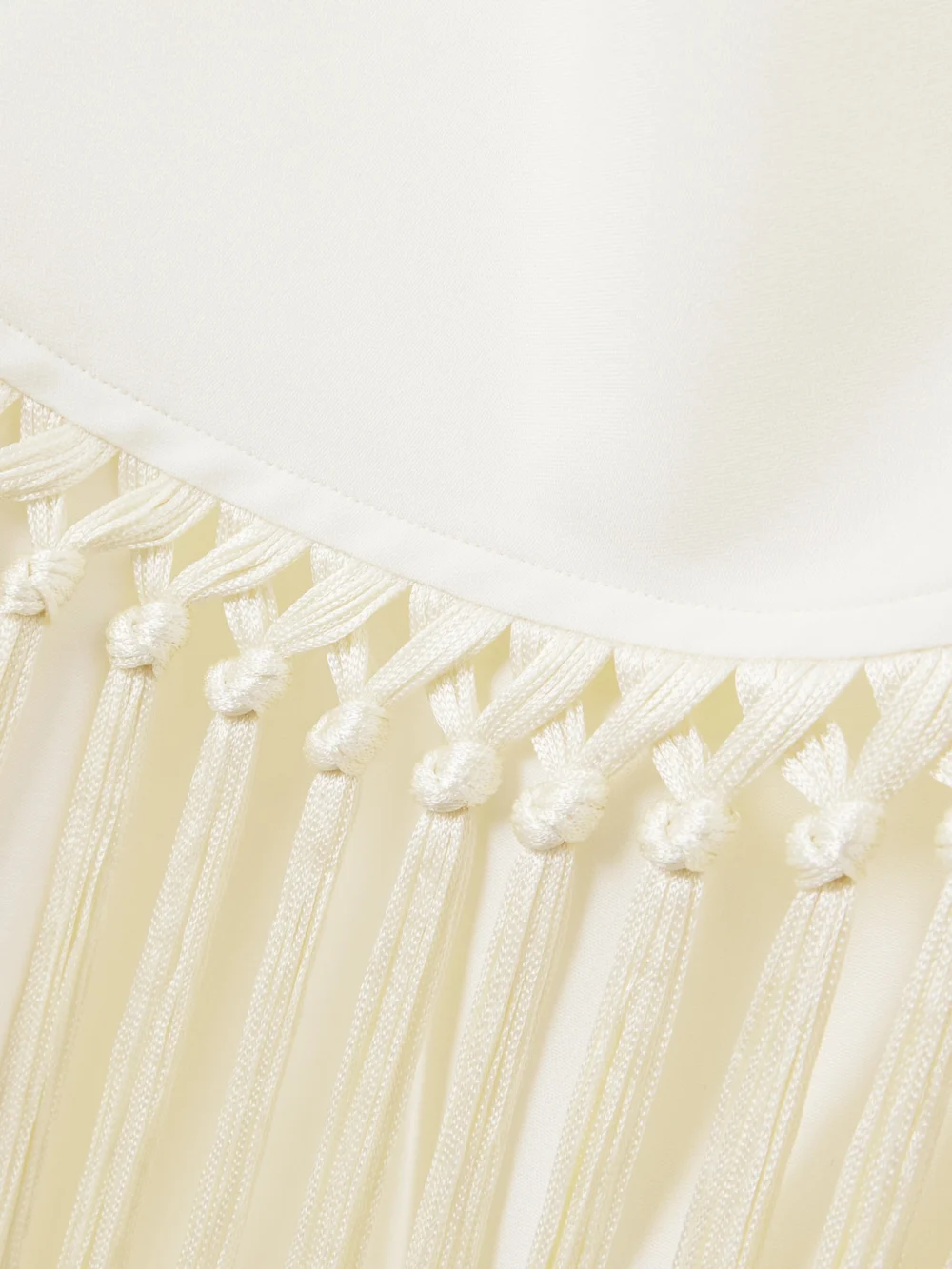 Close-up detail of the Taller Marmo Meteora Tasseled Layered Crepe Halterneck Gown