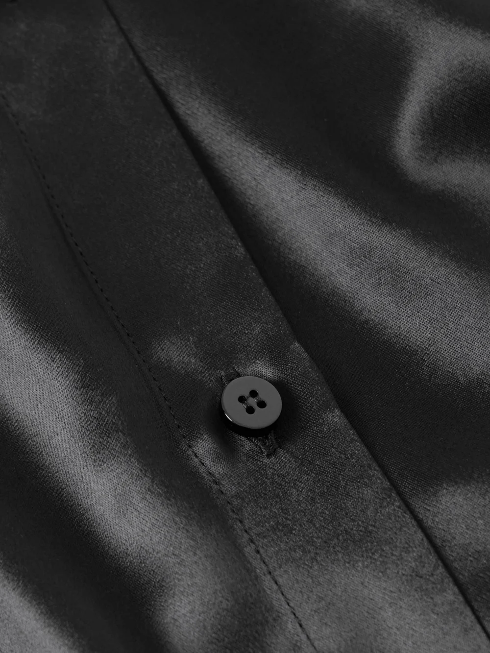 Close-up detail of The Attico Asymmetric Satin Mini Dress