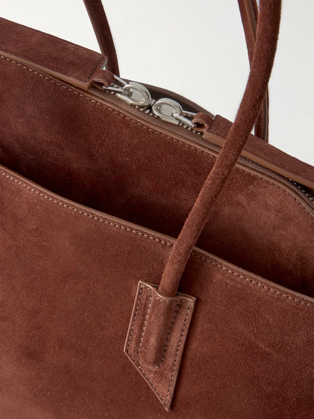 Close-up detail of The Attico La Passeggiata Medium Asymmetric Suede Tote
