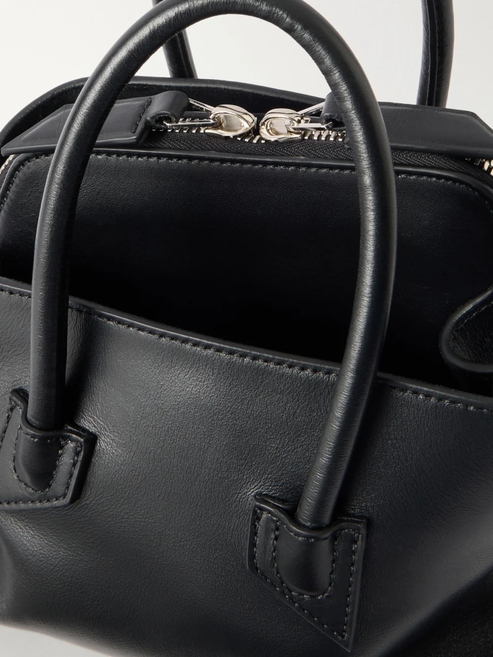 Close-up detail of The Attico La Passeggiata Mini Asymmetric Leather Top-handle Bag