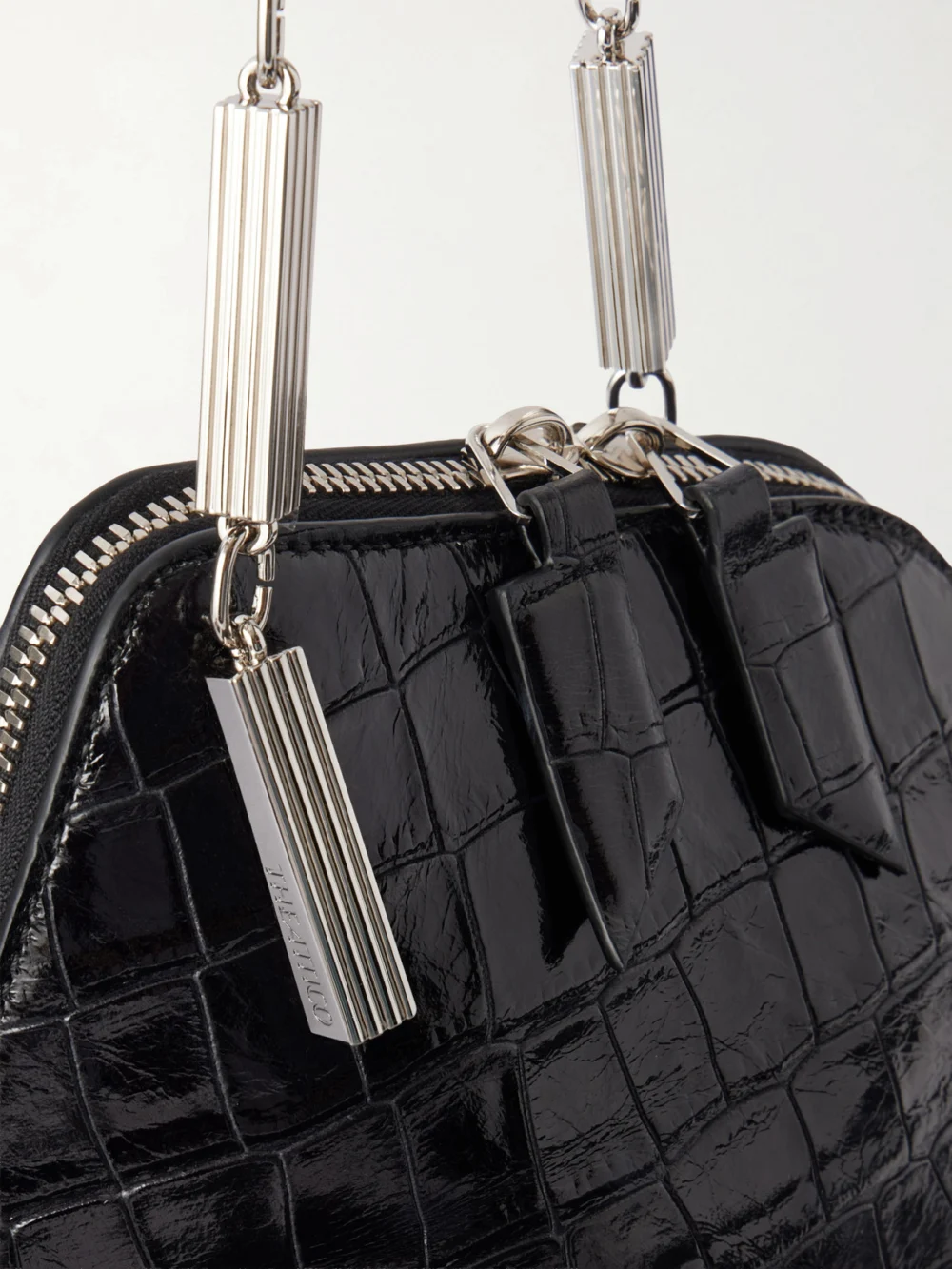 Close-up detail of The Attico La Scala Asymmetric Croc-effect Leather Clutch