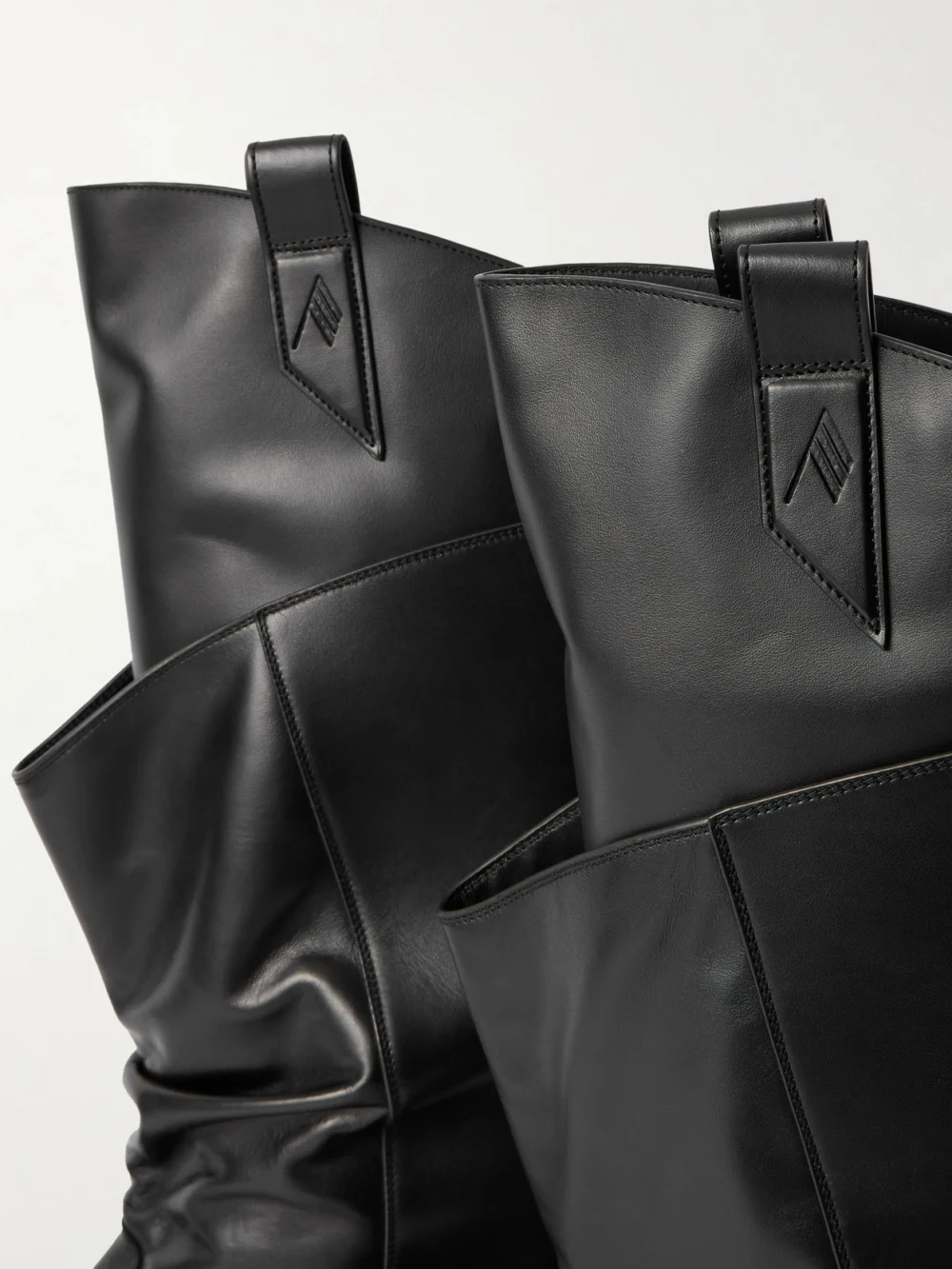 Close-up detail of The Attico Passeggiata Layered Leather Knee Boots