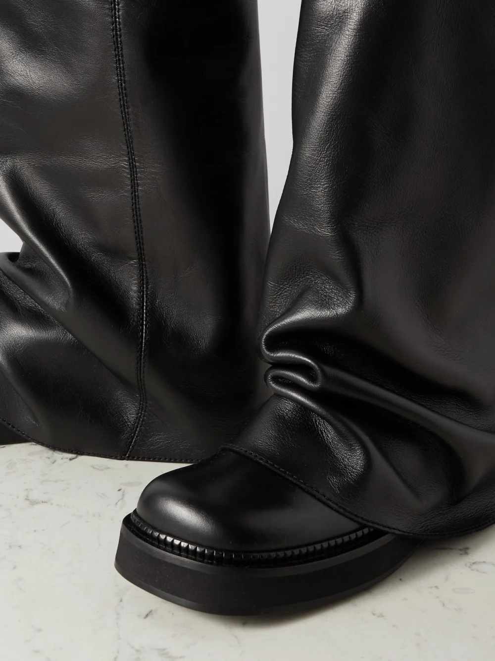Close-up detail of The Attico Robin Layered Leather Knee Boots