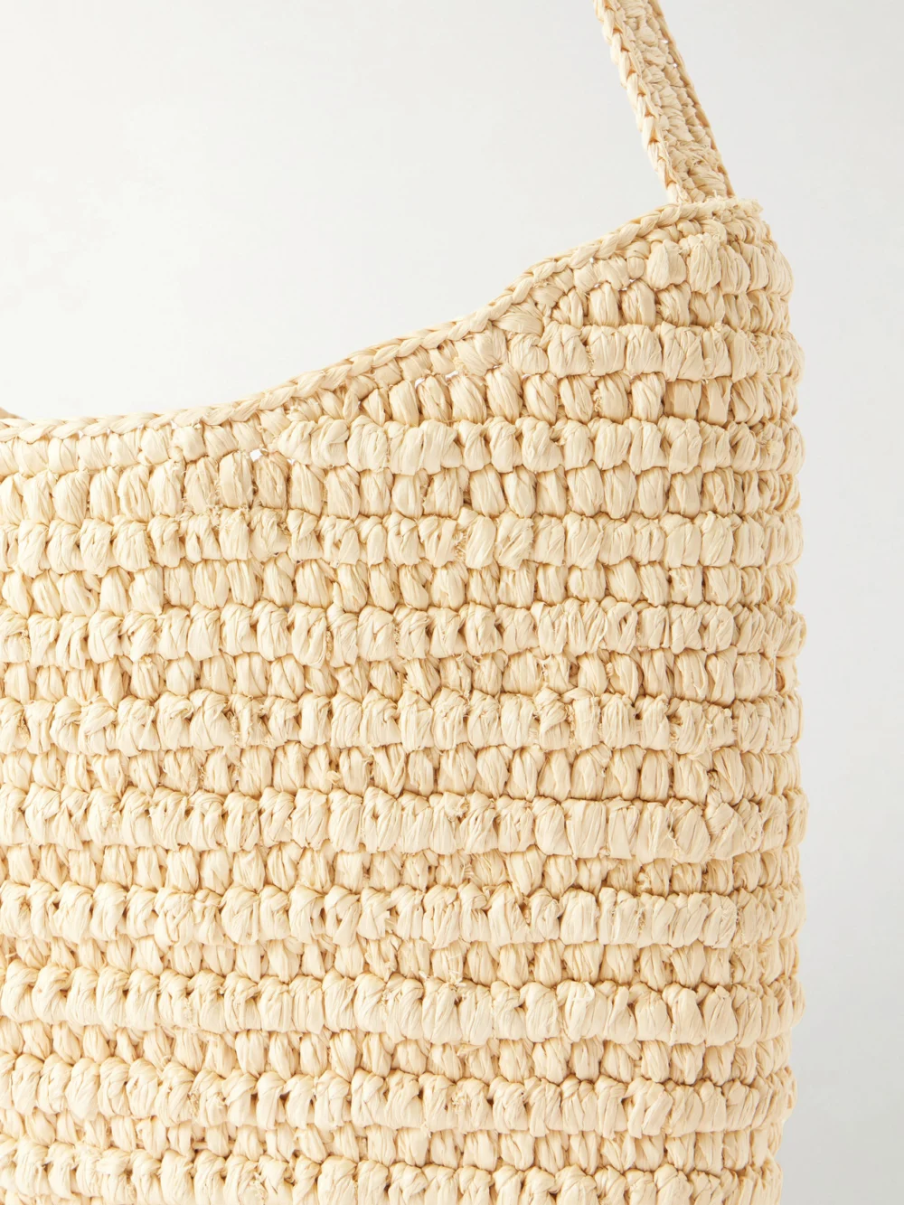 Close-up detail of The Row Alma Leather-trimmed Raffia Shoulder Bag