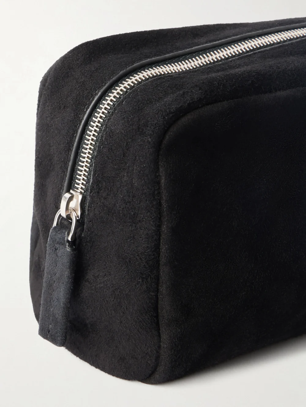 Close-up detail of The Row Astra Suede Pouch