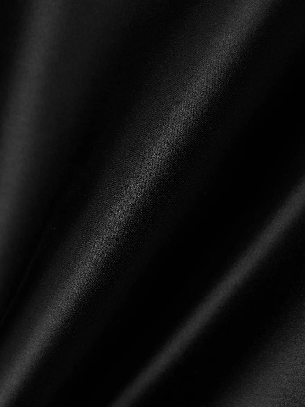 Close-up detail of The Row Athalia Draped Duchesse Silk-satin Midi Skirt