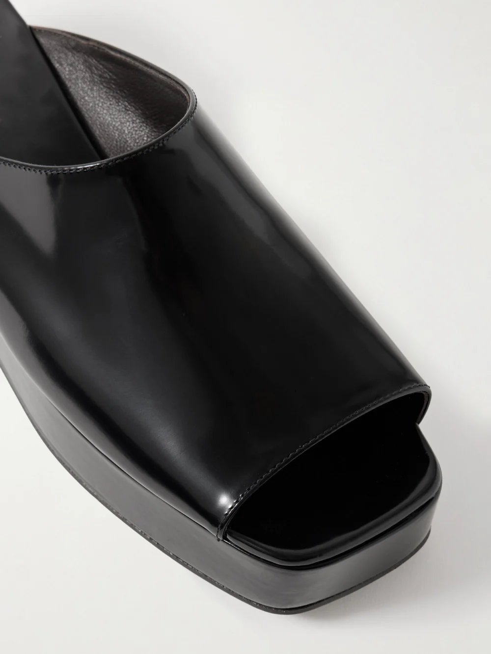 Close-up detail of The Row Emi Flatform Glossed-leather Platform Slides