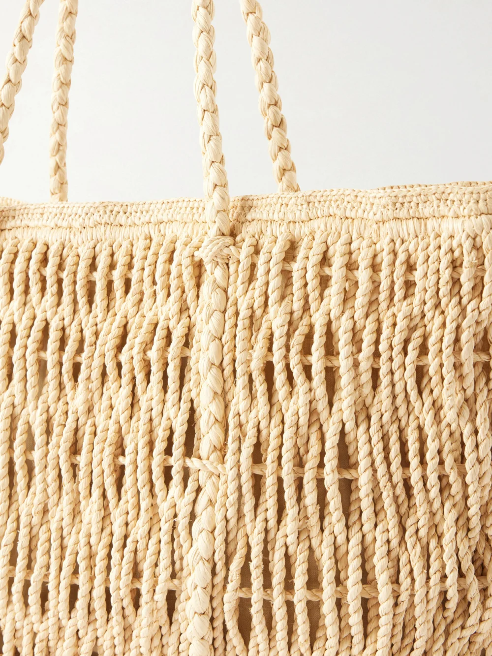 Close-up detail of The Row Georgica Leather-trimmed Raffia Tote