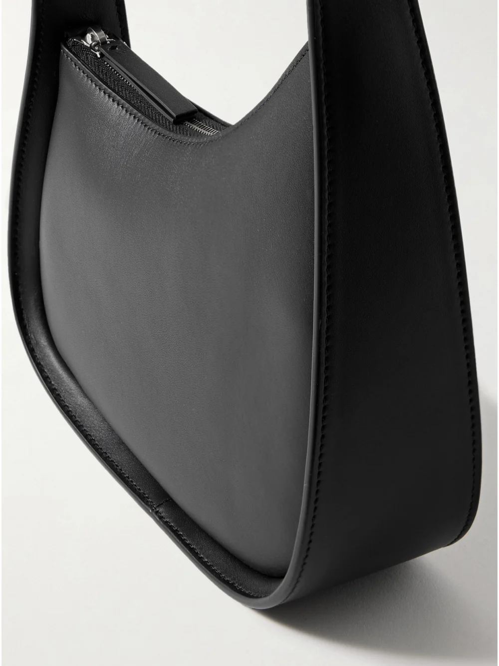Close-up detail of The Row Half Moon Leather Shoulder Bag