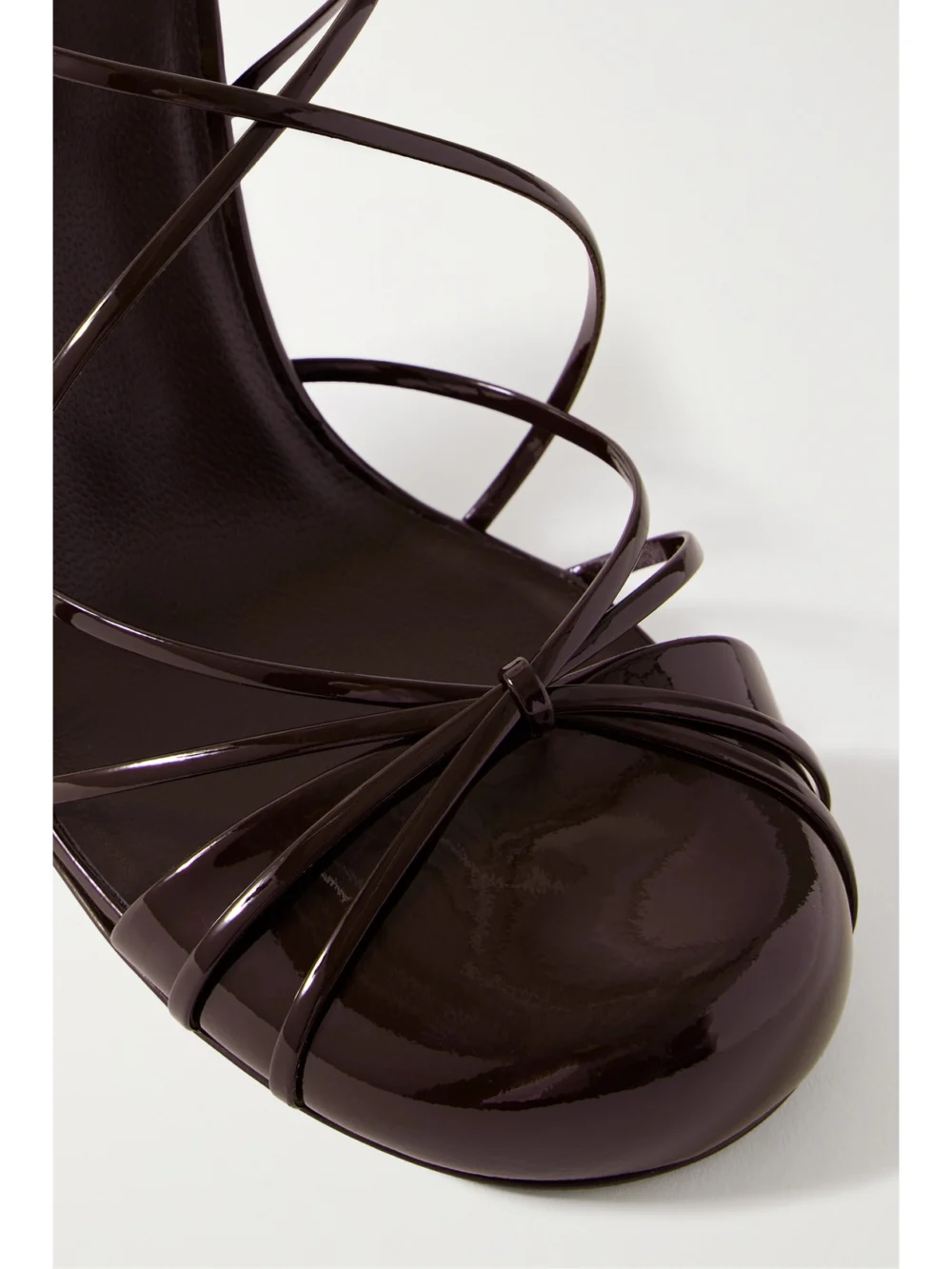 Close-up detail of The Row Joan Lace-up Patent-leather Sandals
