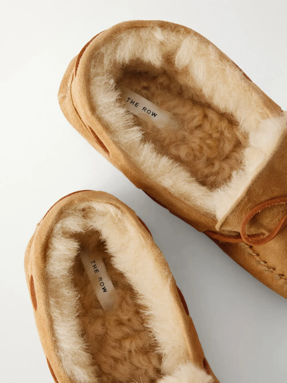 Close-up detail of The Row Lucca Bow-detailed Shearling-lined Suede Loafers